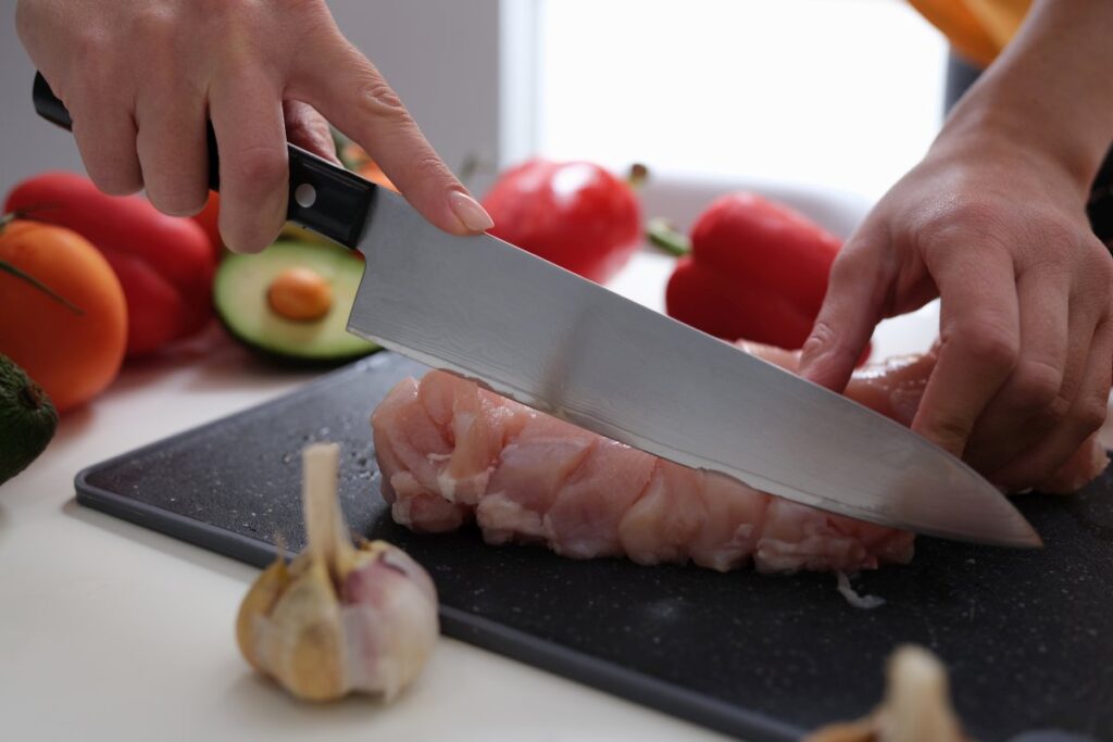 Woman cutting meat with a knife