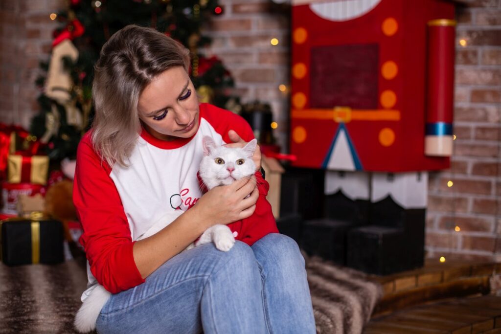 A woman is playing with her lovely cat on Christmas Eve