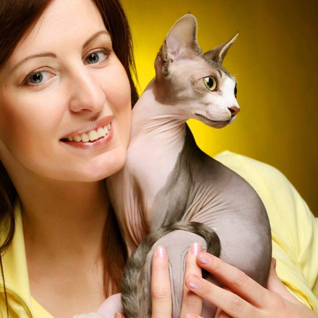 A young woman and her Sphynx cat